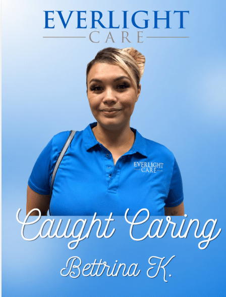 Book cover: 'Caught Caring' by Bettrina K. for Everlight Care, featuring a smiling woman in a blue polo shirt.